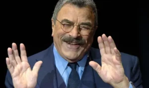 Tom Selleck is laughing while talking on the show.