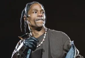 Travis Scott is holding the mic.