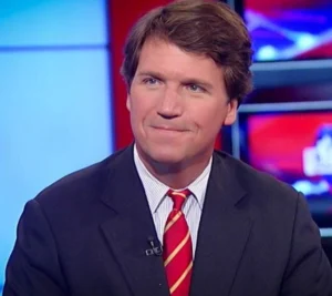 Tucker Carlson is smiling while sitting at a show.