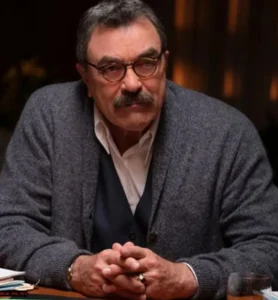 Tom Selleck is wearing glasses.