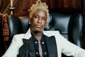 Young Thug is sitting on the couch.