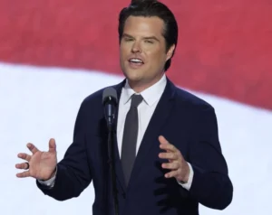 Matt Gaetz is laughing while speaking into the microphone.