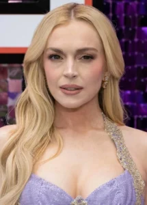 Lindsay Lohan looks on in surprise, wearing a blue dress.