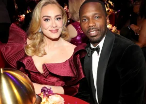Adele and Rich Paul elegantly seated at a glamorous event.