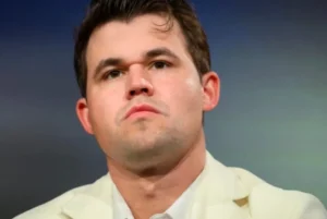 Magnus Carlsen sits sad.