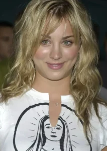 Kaley Cuoco is smiling while wearing white.