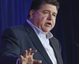 JB Pritzker is speaking into the mic.