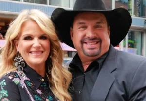Garth Brooks and his wife are standing laughing.