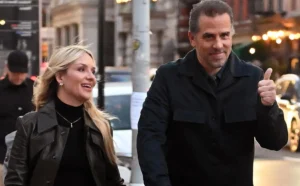 Hunter Biden is laughing while hanging out with a girl outside.