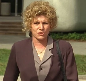 Leslie Abramson is standing outside wearing a coat.