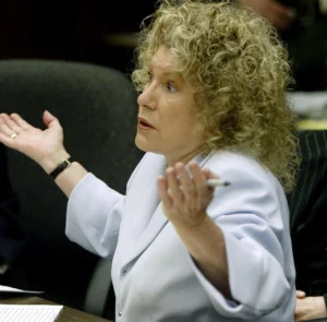 Leslie Abramson is expressing surprise, pen in hand.