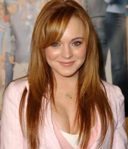 Lindsay Lohan is smiling with her hair down.