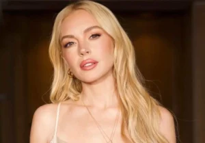 Lindsay Lohan is standing with her hair down.