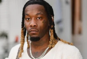 Offset stands sad, wearing a white shirt.