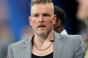 Pete McAfee is standing outside in a gray coat.